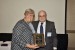 Dr. Nagib Callaos, General Chair, giving Prof. Lorayne Robertson a plaque "In Appreciation for Delivering a Great Keynote Address at a Plenary Session."